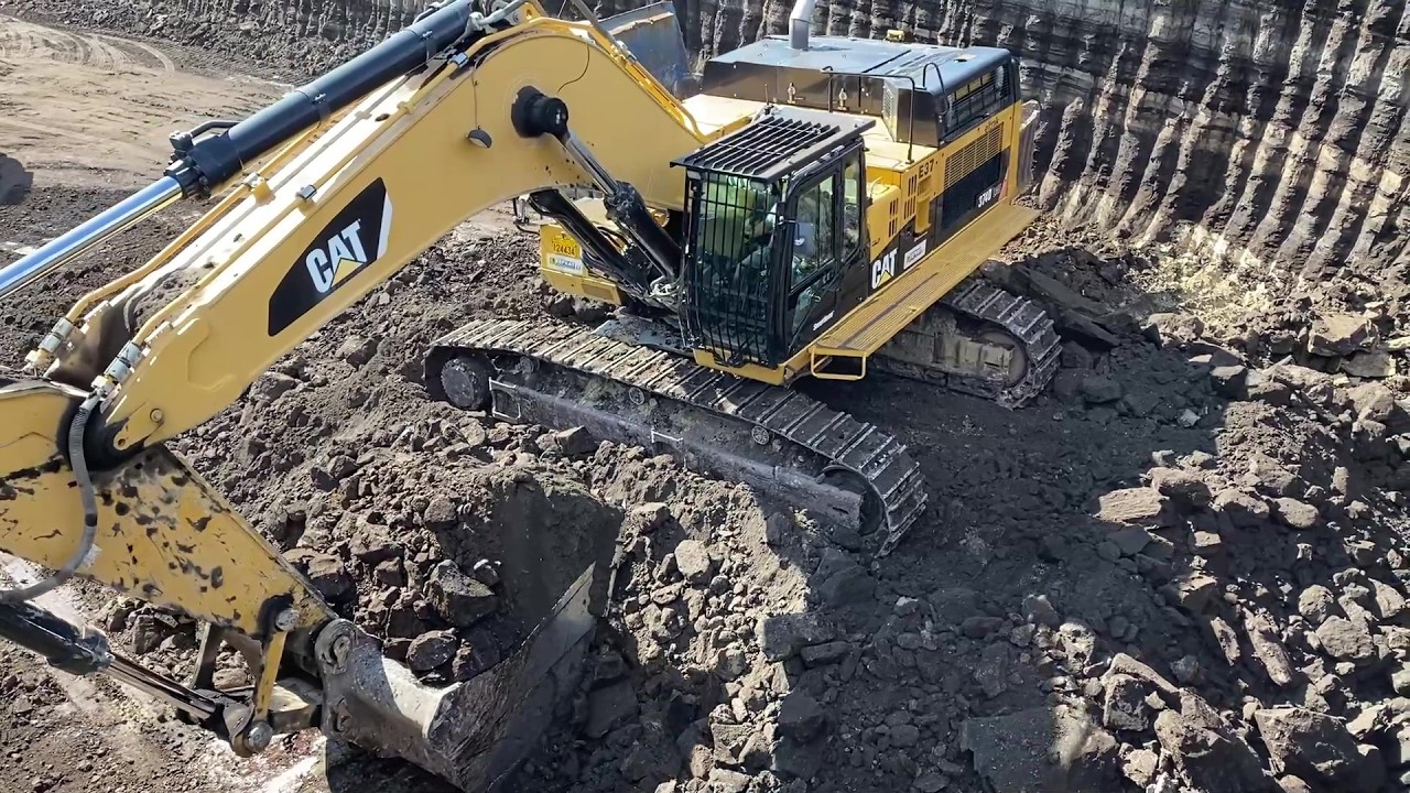 Caterpillar 374D Excavator Working On Mines, Loading Overburden On 4 ...