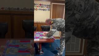 Captain of HMAS Canberra Signs a 15th Anniversary Laundry Bag