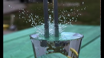 Vibrating tuning fork plunged into water in slow motion