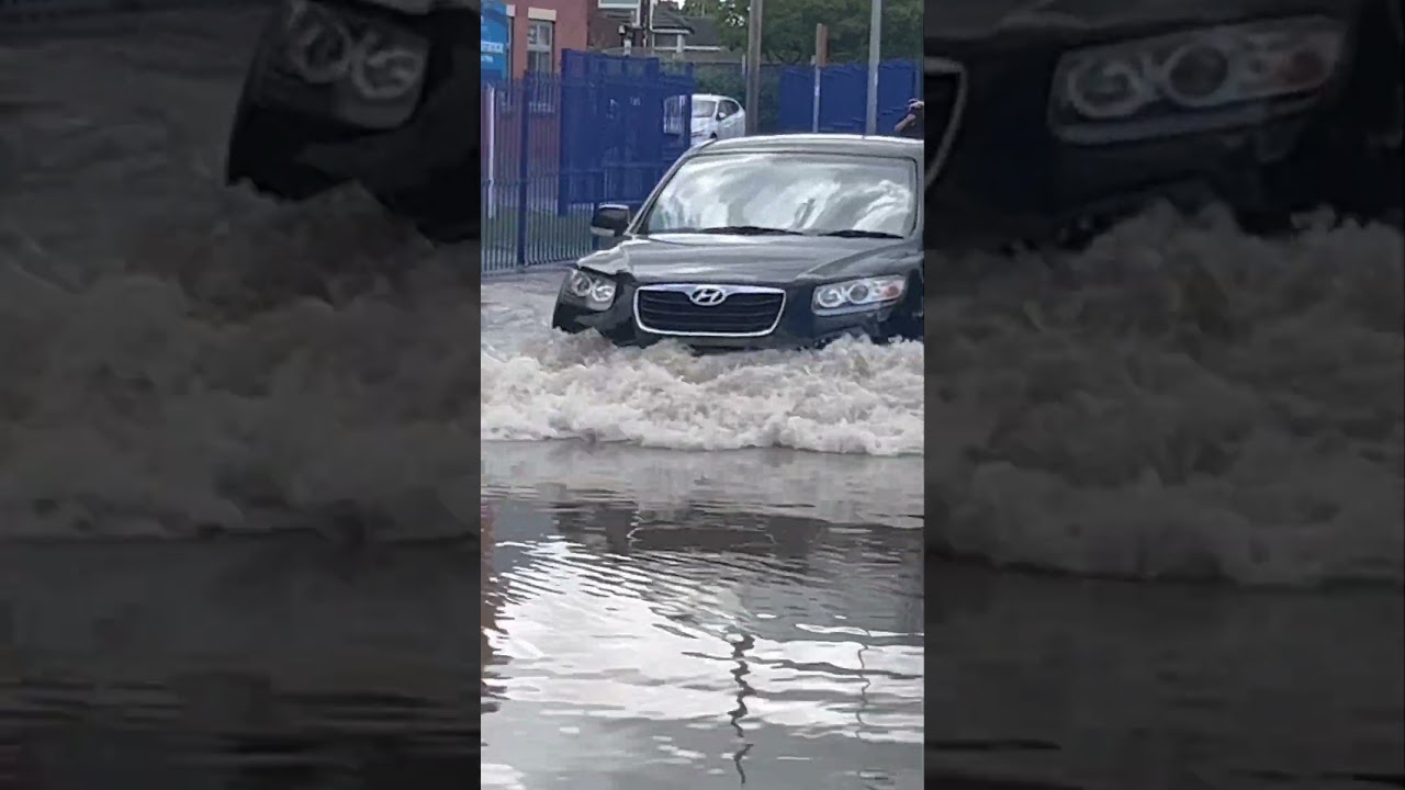 Cars go through water/ Flooded road 