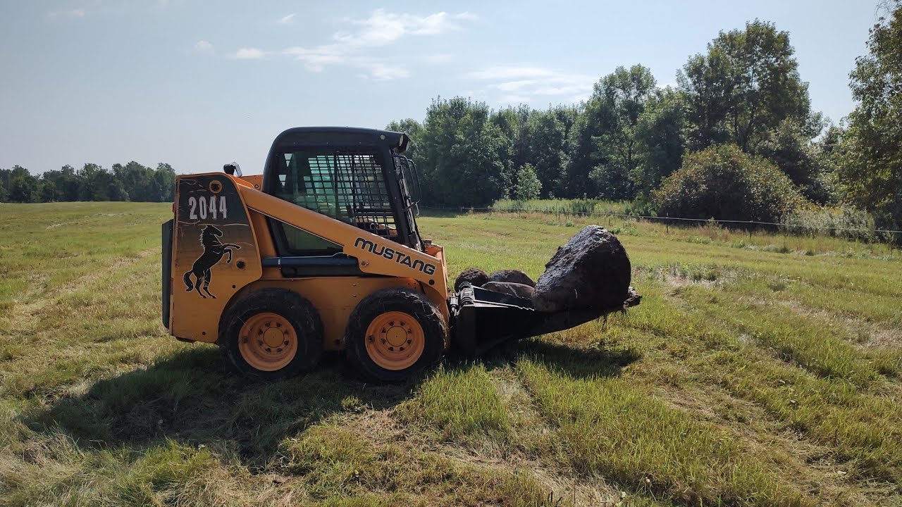 Mowing brush, popping rocks and pulling trees - YouTube