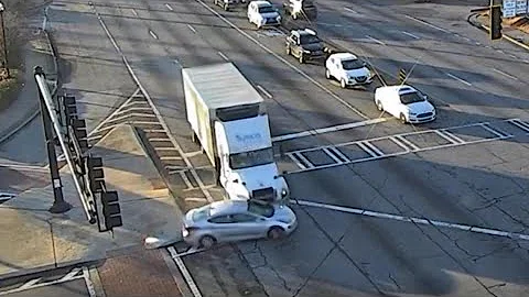 Truck hits car, keeps pushing it through two intersections | Traffic & dashcam video