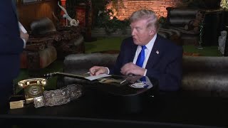 Donald Trump signs replica of one of Elvis Presley's guitars at Graceland