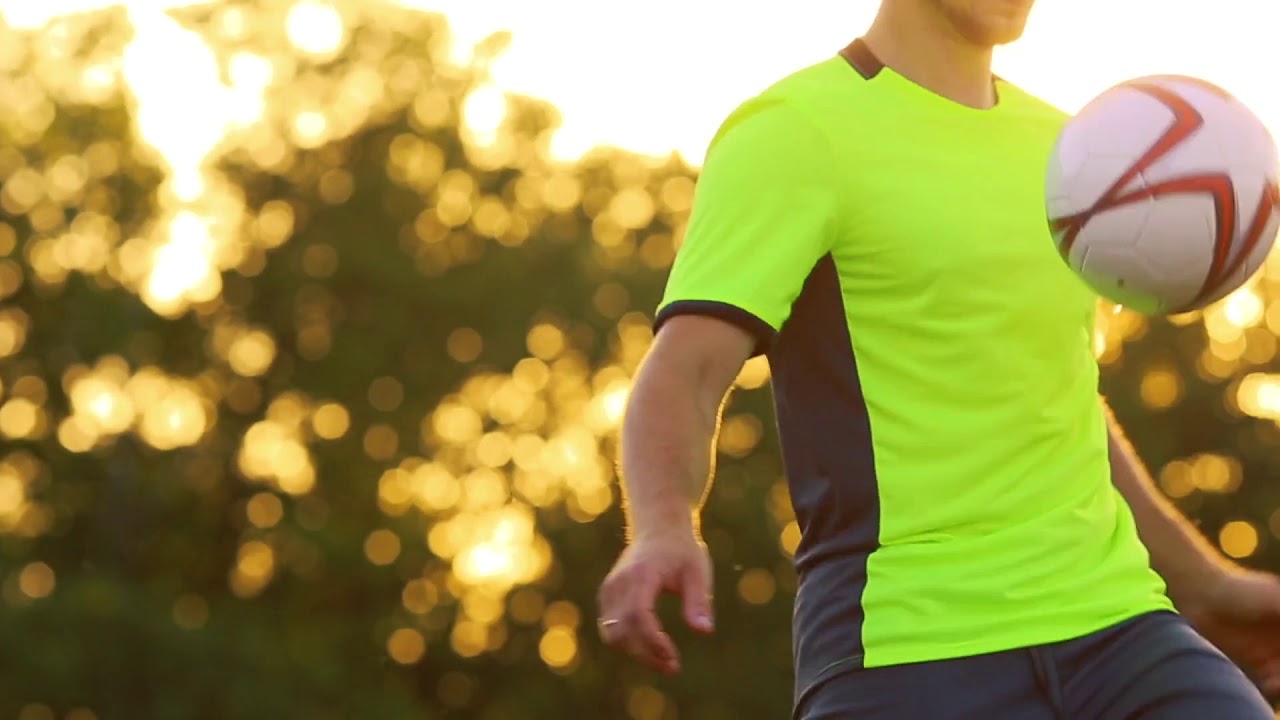 a professional football player and a man in a green uniform knees
