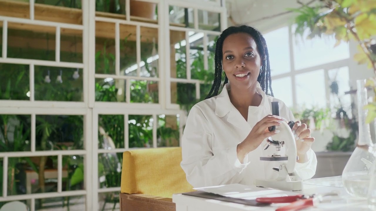 Joyful Scientist: Microscope Exploration with a Happy Female Researcher | 4K Stock Footage