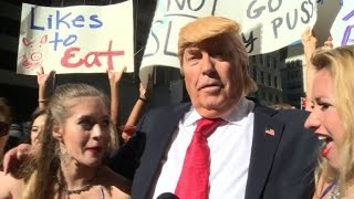 Bikini-clad models surround fake Trump in NYC stunt