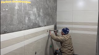 Construction Worker Installs Ceramic Tiles For Modern Bathroom Walls - Tiling Skills
