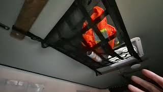 Truck Camper Organization with ceiling cargo nets and velco pockets in our @ovrlndcampers