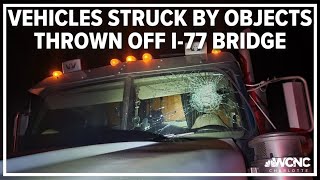 Vehicles struck by objects, including concrete block, thrown off I-77 bridge
