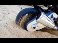 The power wheels sport bike stuck in the sand