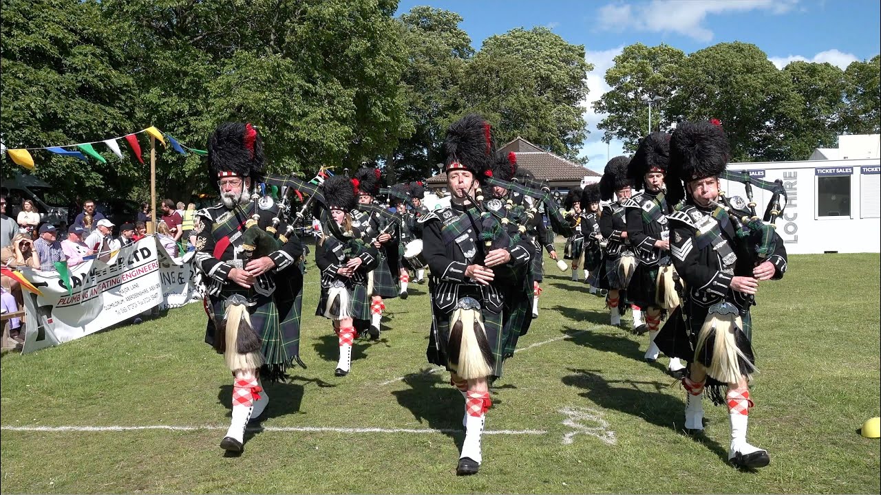 Lonach Pipe Band march on playing Minstrel Boy during 2022 Oldmeldrum Sports & Highland Games