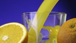 Orange Juice Pouring In Glass On Color Background Stock Footage - Hive