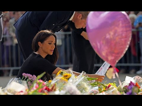 Meghan, Duchess of Sussex looks teary as she visits flowers laid at ...