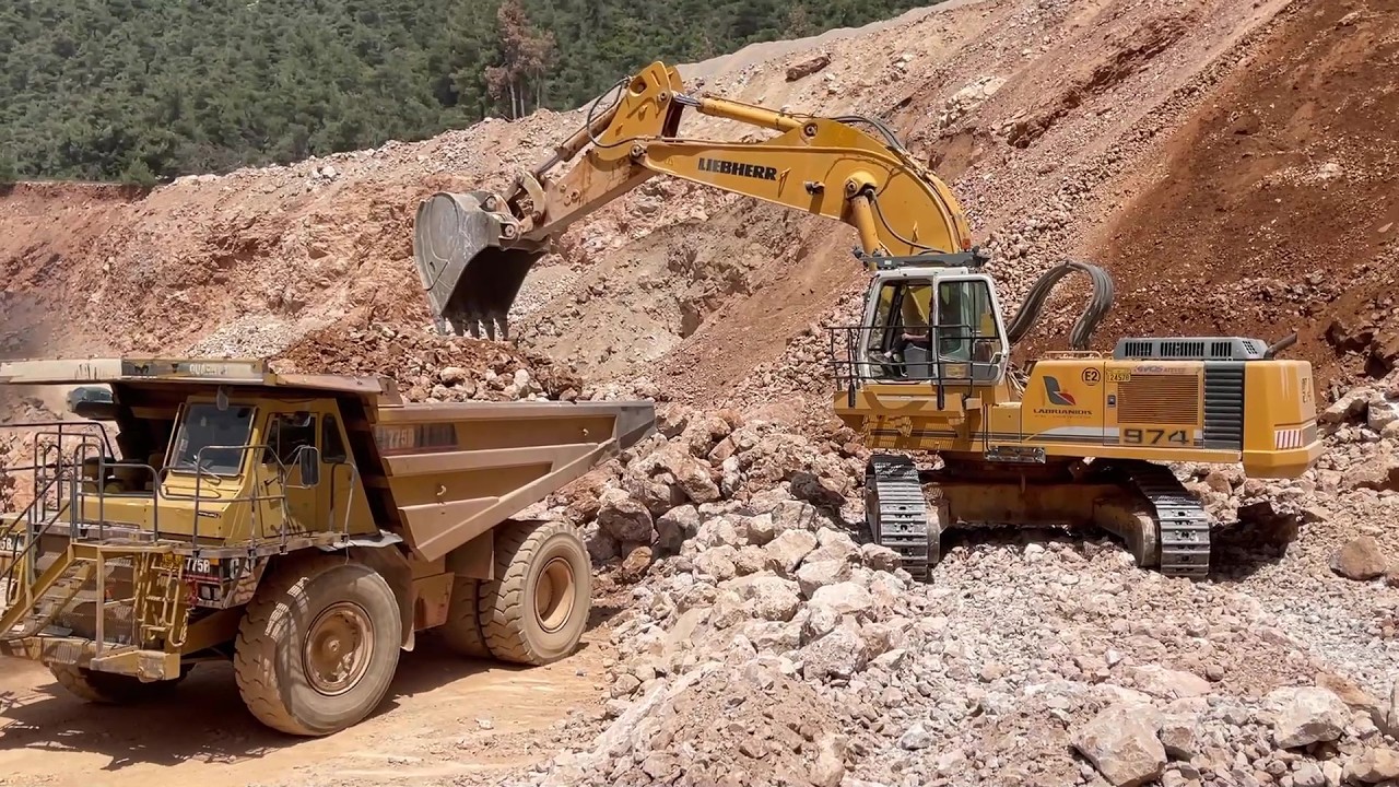 Liebherr 974 Excavator Loading Blasted Rock Onto CAT 775B Dumper At Quarry - Sotiriadis/Labrianidis