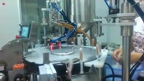 Automatic dual head syringe filling capping machine