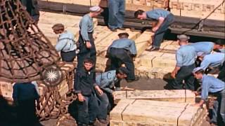 Men on deck of AE (ammunition ship) load crates into cargo net, Pacific Ocean. HD Stock Footage