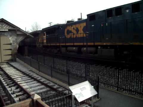 A CSX freight heads west past the B&O Railroad Mus...