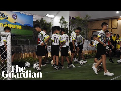 Rescued Thai boys kick footballs at beginning of press conference