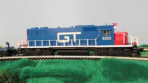 GTW 6252, SD38, pulling a long freight train of 1960's to 1980's era O scale freight cars, caboose