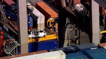 VideoVault Stock Video: Crane unloading container from container ship during the day