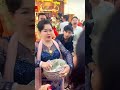 Donor Scattering Money at a Monastery Dhamma Hall
