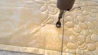 Free motion machine quilting a flower design