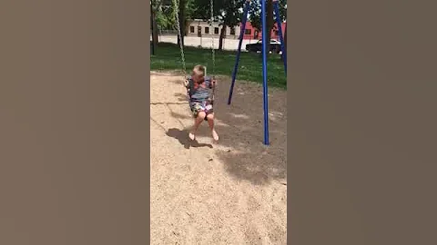 My son doing a back flip on a swing