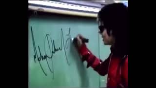 Michael Jackson giving his autograph