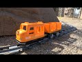 Lego Duplo 2 electric blue locomotives and an orange train, running in the park