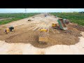 Dump trucks and bulldozers working | dump truck dumping dirt, bulldozer pushing dirt