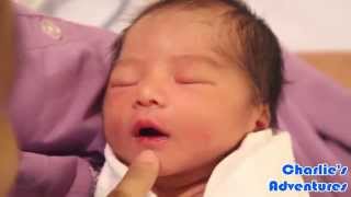 1-day old baby girl shows her dimple upon daddy's request