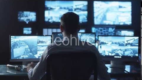 Security Officer Drinking Coffee while Working on Computer in Monitoring | VideoHive 14741637