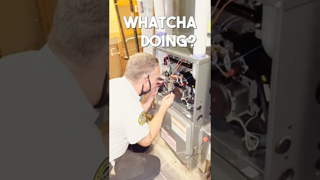 HVAC Technician Cleaning Out Pressure Switch Hoses 