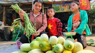 Dia happily harvests cowpeas and giant melons with her children to sell at the market.