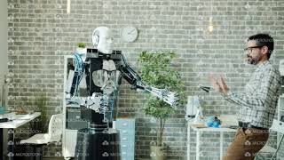 Happy Developer Dancing In Office Room With Smart Robot Having Fun At Work