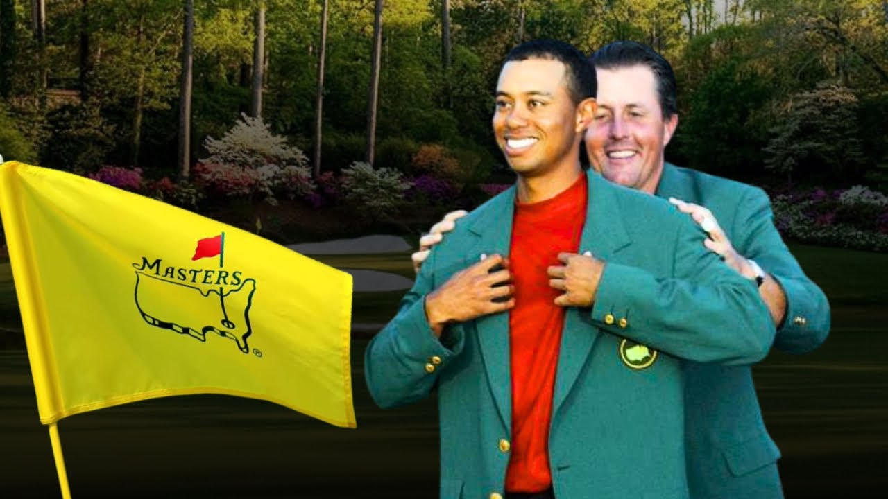 Phil Mickelson putting the green jacket on Tiger Woods