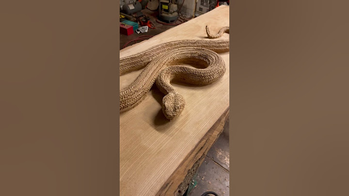 Chipping on a rattlesnake table. #scottdowart #woodcarving