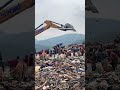 Rag picker searching for recyclable materials in a dumpsite in Guwahati, India.