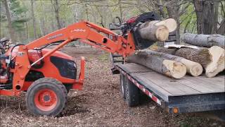 Grapple skills loading logs on a trailer with kubota tractor and
grapple.