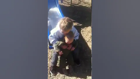 Sliding with his oldest brother.