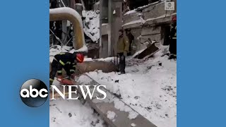 Ukrainian emergency workers clear rubble from airstrike
