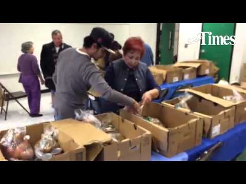 The Aoy Elementary School Alumni Association prepares Thanksgiving food boxes for the school's poore