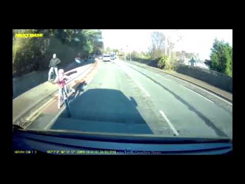 Heart-stopping moment girl on oversized bike careers off pavement and into the path of van