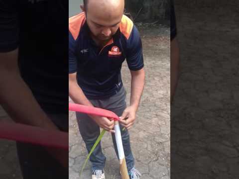 How do you put a new grip on a cricket bat?
