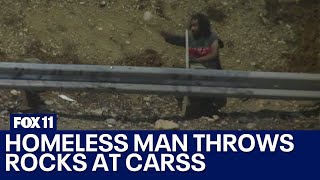 Homeless man seen on video throwing rocks onto 110 Freeway in South LA