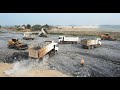 A lot Of Heavy Machinery , Powerful Wheels Loader SDLG and SACMAN Loading Trucks Transporting Rocks