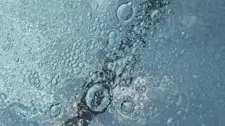 Swimming pool jets with bubbles artistic in slow motion.