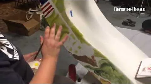 Artists Celia Eaby, Carrie Fredrickson work on a h...