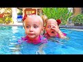 Kids play in Water Park and Giant swimming pool with Dinosaurs