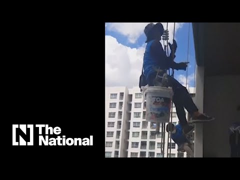 Thai woman cut rope to leave painters hanging above 26th floor, police say